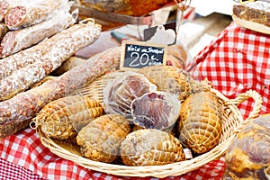 French saucissons and ham display in market in south of France