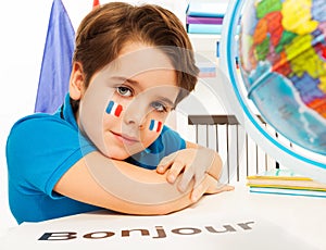 French schoolboy learning geography with the globe