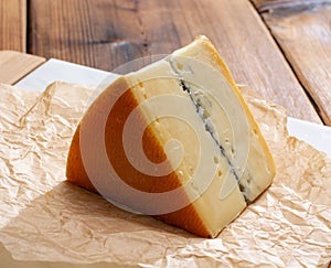 French semi-soft cow milk cheese morbier from Franche-Comte region with thin black layer and strong aroma