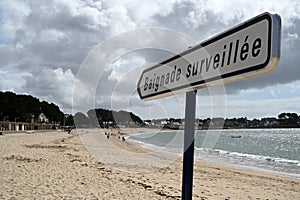 French sign indicating supervised beach on Trez beach in Benodet