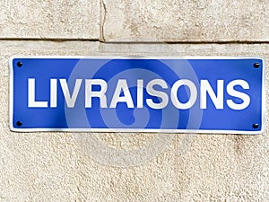 French sign livraisons means deliveries on stone wall