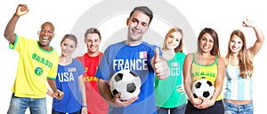 French soccer fan with football showing thumb up with other fans