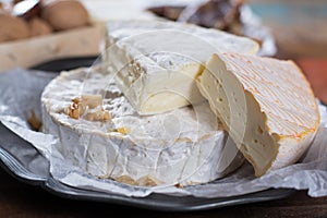 French soft cheeses - camembert, marcaire, munster, brie - delicious dessert with nuts and dried fruits