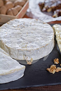 French soft cheeses - camembert, marcaire, munster, brie - delicious dessert with nuts and dried fruits