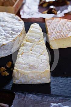 French soft cheeses - camembert, marcaire, munster, brie - delicious dessert with nuts and dried fruits