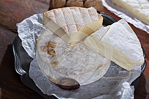 French soft cheeses - camembert, marcaire, munster, brie - delicious dessert with nuts and dried fruits