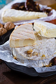 French soft cheeses - camembert, marcaire, munster, brie - delicious dessert with nuts and dried fruits