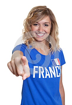 French sports with blond hair pointing at camera