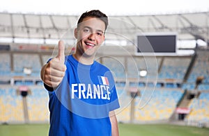 French sports fan at stadium showing thumb up