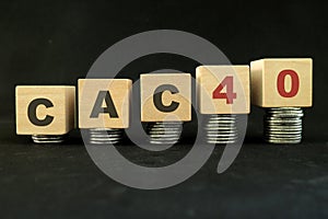 French stock market economy growth and recovery concept. CAC40 index in wooden blocks with increasing stack of coins in black back