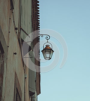 French Streetlight hanged on a building.