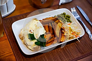 French style meat in Mornay sauce with vegetable garnish