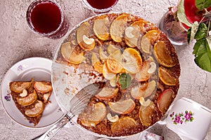 French sweet pie tart tatin apple cake upside down  over on gray concrete background. Top view