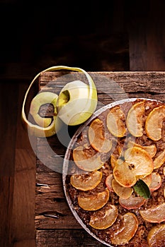 French sweet pie tart tatin apple cake upside down over on old rustic wooden background. Top view