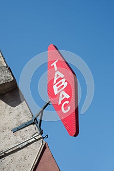 French tabacco sign with french text tabac, the traduction in english of tobacco on store front on blue sky background