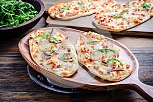 French tarte flambee with cream cheese, bacon and onions. Flammkuchen from Alsace region