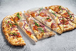 French tarte flambee with cream cheese, bacon, tomato and onions. Flammkuchen from Alsace region. White background. Top