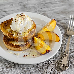 French toast with ice cream and honey on a white plate