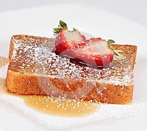 French toast with powdered sugar and a strawberry
