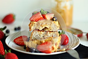 French toast with strawberries, blueberries and peanut butter.