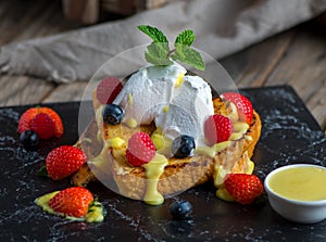 french toast with strawberry, blackberry, cream and basil served in a dish isolated on cutting board side view of breakfast on