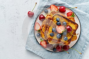 French toasts with berries, brioche breakfast, white background top view copy space