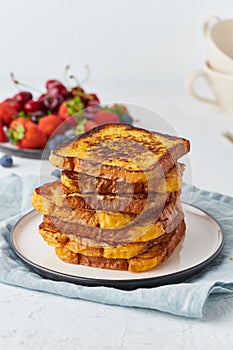 French toasts with berries, brioche breakfast, white background, vertical closeup