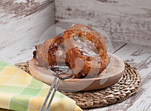 French toasts on a wooden plate.