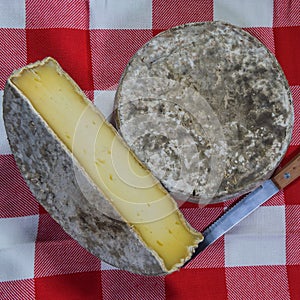 French tomme cheese for sale on a market stall