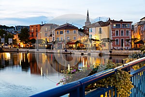 French town of Martigues overlooking buildings on bank of canal at dusk