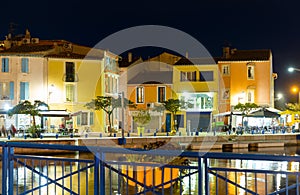 French town of Martigues overlooking buildings on bank of canal at dusk