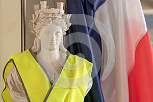 The French tricolor and Marianne, the symbols of the Republic and the yellow jackets protester Gilet jaune