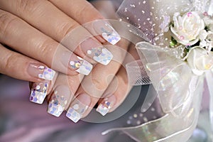 French wedding manicure with translucent glitters, white dots