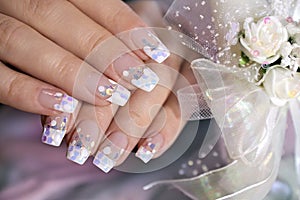 French wedding manicure with translucent glitters, white dots photo