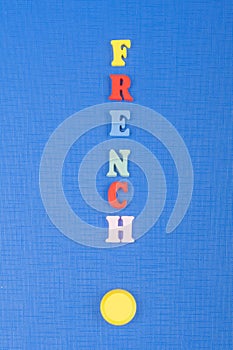 FRENCH word on blue background composed from colorful abc alphabet block wooden letters, copy space for ad text. Learning