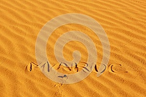 French word Maroc written on the sand