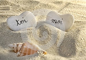 French you and me hearts of pebbles in the sand