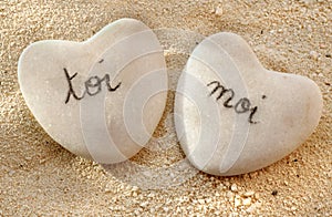 French you and me hearts of pebbles in the sand