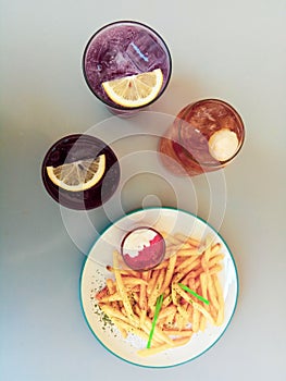 Frenchfries with a colorful drink