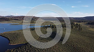 Frenchman Lake reservoir in California west shore hills and trees drone high POV photo