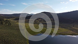 Frenchman Lake reservoir in California west shore surrounded by mountains hills and trees drone high POV photo