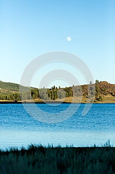 Frenchman lake at sunset land and water with full moon in the sky