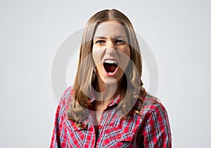 Frenzied young woman screaming with anger.