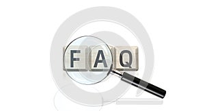 Frequently asked question concept, faw writing on cubes and magnifier