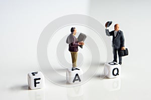 frequently asked questions abbreviation with miniature businessmen figurines having a gathering