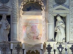Fresco with Madonna and Child flanked by saints statues in the main altar of the Church of San Biagio.