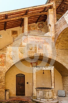 Fresco paintings on a staircase in an Italian courtyard