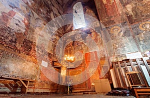 Fresco wall and candle lights inside the hall of Church of the Archangels, Georgia.