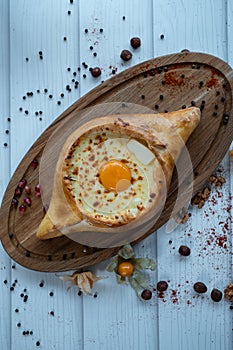 fresh adjarian khachapuri boat woth suluguni cheese, egg yolk and butter