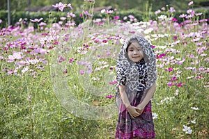 Resh air and good health of asian kid breezing on agriculture daisy photo